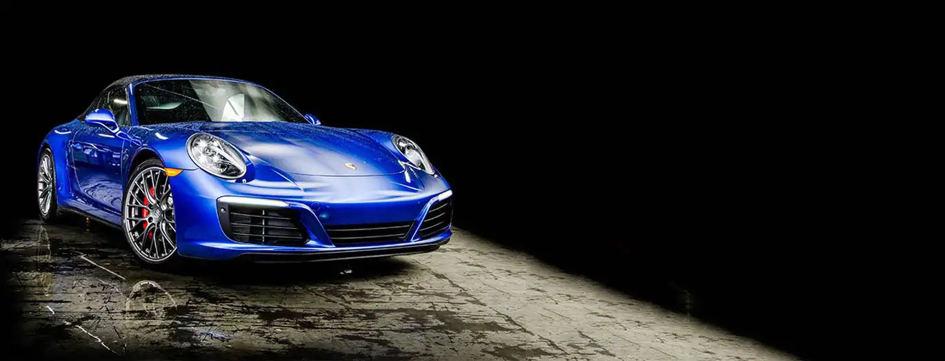 Blue Porsche on a black background