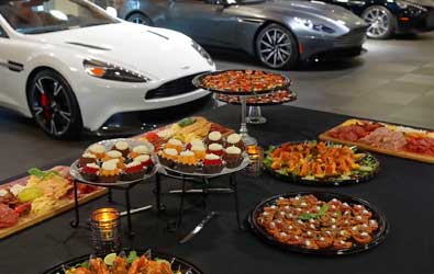 food laid out on a table with a white car behind it