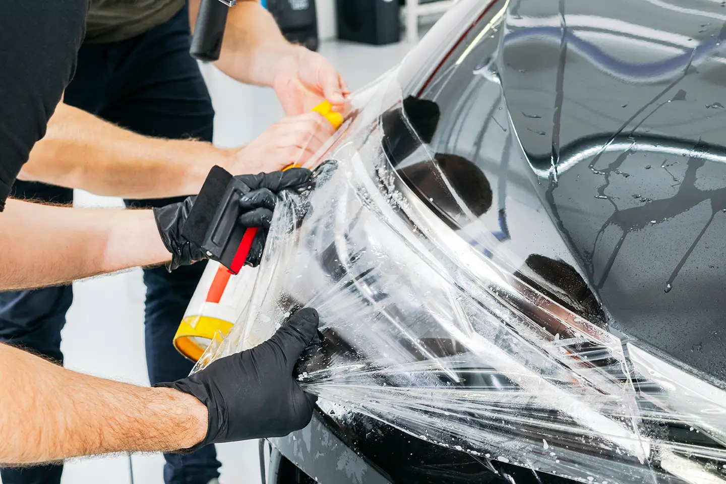Car paint protective film being applied
